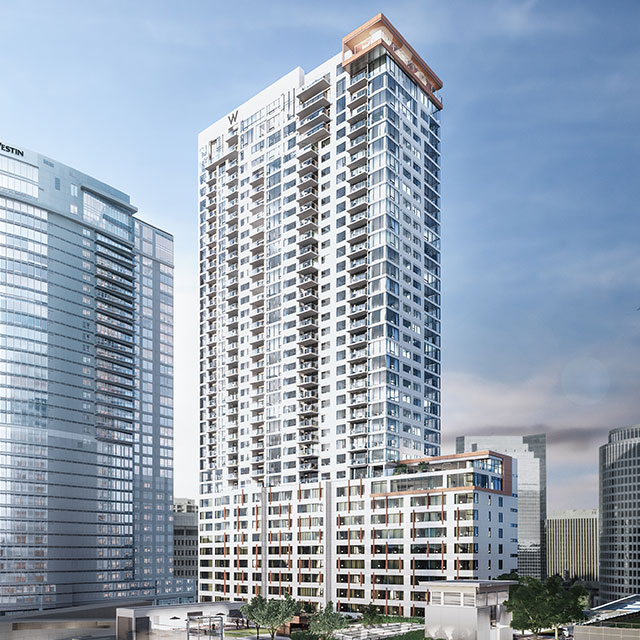 A modern high-rise building with a sleek glass facade, surrounded by other skyscrapers in an urban setting.