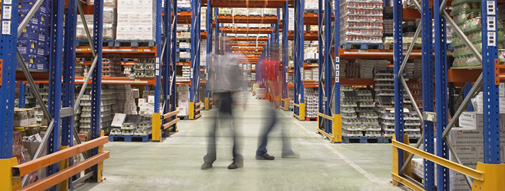 Shady images of two workers in a warehouse.