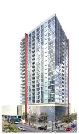 A modern high-rise building with a glass facade and red accents, surrounded by trees and a street with cars.