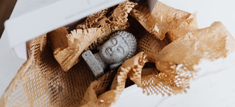 Granite sculpture bust in cardboard package during museum and library relocations